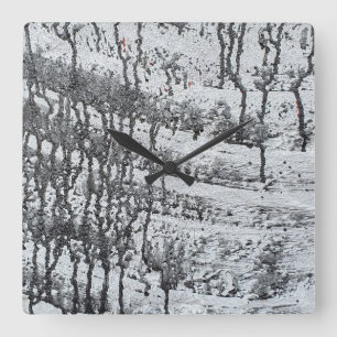 black paint drip on concrete square wall clock