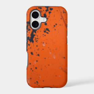 Black paint splatter on orange