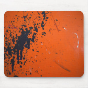Black paint splatter on orange mouse pad