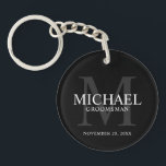 Black Personalised Groomsmen's name and monogram Key Ring<br><div class="desc">Add a personal touch to your wedding with personalised groomsmen keychain. This keychain features personalised groomsman's name with title and wedding date in white and monogram in grey as background, in classic serif font style, on black background. Also perfect for best man, father of the bride, ring bearer and more....</div>