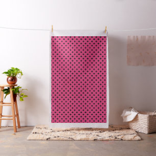 Black polka crosses on fuchsia fabric