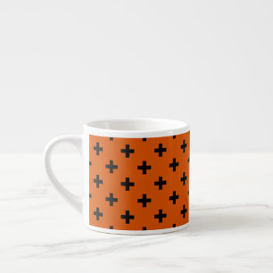 Black polka crosses on orange espresso cup