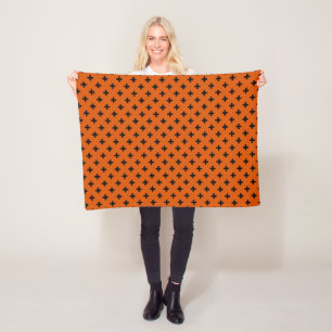 Black polka crosses on orange fleece blanket