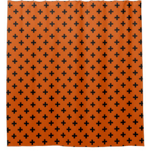 Black polka crosses on orange shower curtain