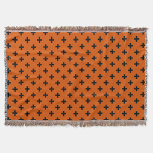Black polka crosses on orange throw blanket