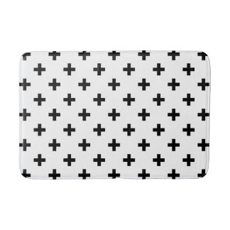 Black polka crosses on white bath mat