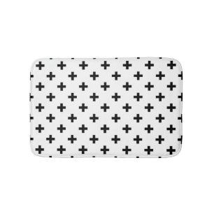 Black polka crosses on white bath mat