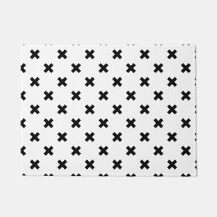 Black polka crosses on white doormat