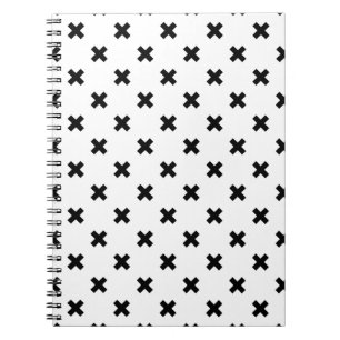 Black polka crosses on white notebook