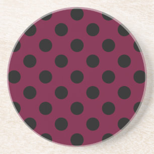 Black polka dots on burgundy coaster