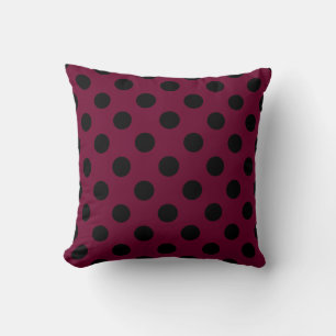 Black polka dots on burgundy cushion