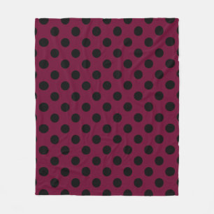 Black polka dots on burgundy fleece blanket