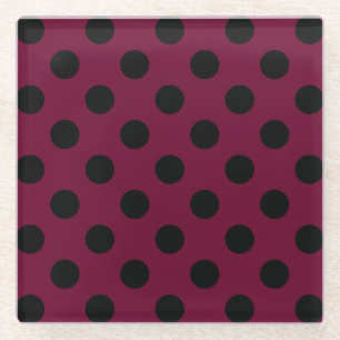 Black polka dots on burgundy glass coaster