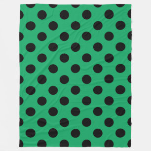 Black polka dots on fresh green fleece blanket