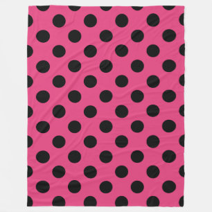 Black polka dots on fuchsia fleece blanket