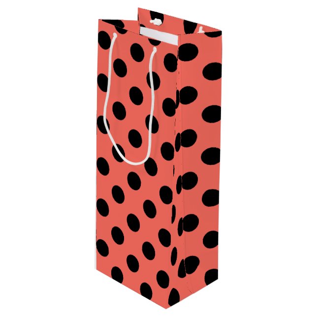 Black polka dots on living coral wine gift bag (Front Angled)