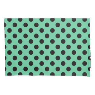 Black polka dots on mint green pillowcase