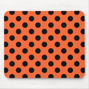 Black polka dots on orange mouse pad
