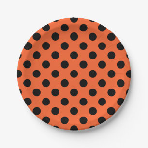 Black polka dots on orange paper plate