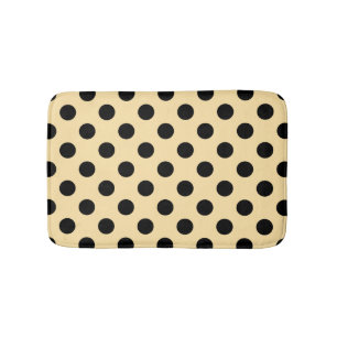 Black polka dots on pale yellow bath mat