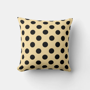 Black polka dots on pale yellow cushion