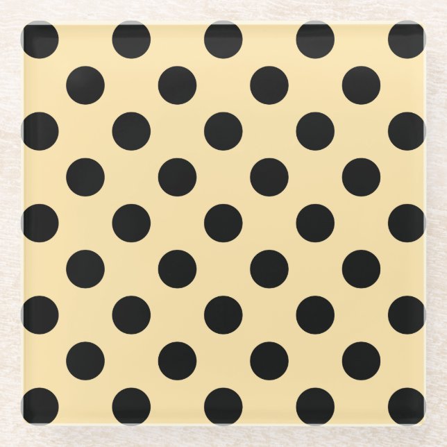 Black polka dots on pale yellow glass coaster (Front)