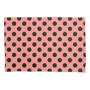 Black polka dots on peach pillowcase