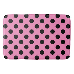 Black polka dots on pink bath mat