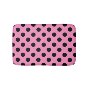 Black polka dots on pink bath mat