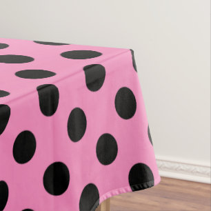 Black polka dots on pink tablecloth