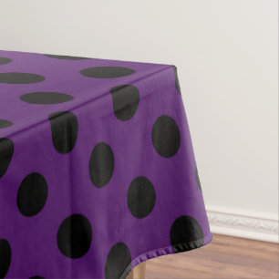Black polka dots on plum purple tablecloth