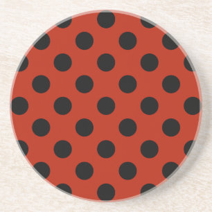 Black polka dots on red coaster