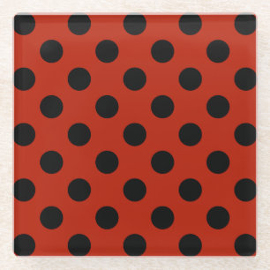 Black polka dots on red glass coaster