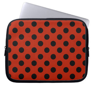 Black polka dots on red laptop sleeve