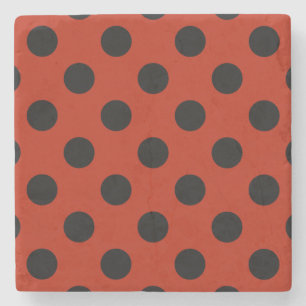 Black polka dots on red stone coaster