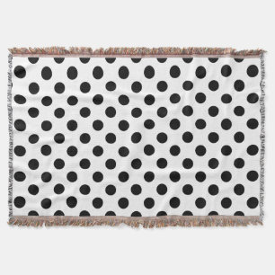 Black polka dots on white throw blanket
