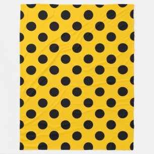 Black polka dots on yellow fleece blanket
