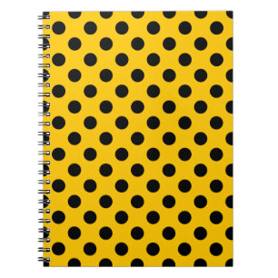 Black polka dots on yellow notebook
