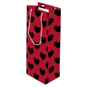 Black polka hearts on red wine gift bag