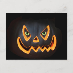 Black pumpkin with cat eyes postcard