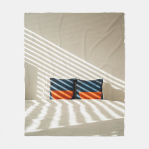 Black red and white plaid textile on white bed fleece blanket