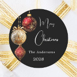 Black red gold baubles classic Christmas Classic Round Sticker<br><div class="desc">For a Christmas party favours or gift wrapping. A modern black coloured background. Decorated with red and gold baubles.  Personalise and add your name,  year.  Text: Merry Christmas</div>