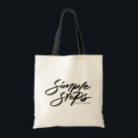 Black Simple Steps Quote Modern Calligraphy Tote Bag<br><div class="desc">The "Simple Steps" tote bag is the perfect combination of modern design and practicality. Crafted from durable canvas,  it’s great for carrying your essentials. You can personalize this black and white with your name or a meaningful phrase,  making it a unique and functional accessory for everyday use.</div>