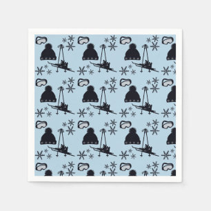 Black ski equipment & snowflakes on blue napkin