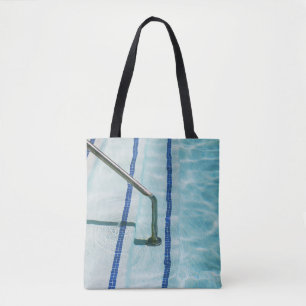 Black strap on blue swimming pool tote bag