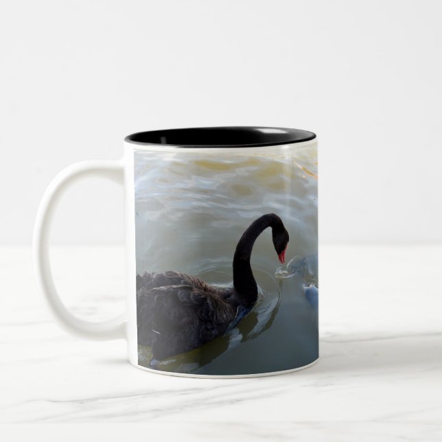 Black Swan Being Attacked By Giant Fish, Two-Tone Coffee Mug (Left)