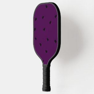 Black tiny holes on purple pickleball paddle