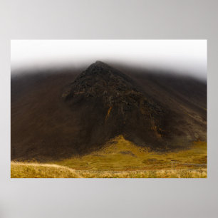 Black volcanic mountain and low clouds poster