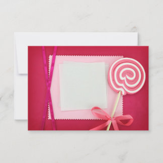 Blank card with lollipop on pink background