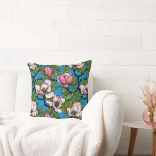 Blooming magnolia on blue cushion